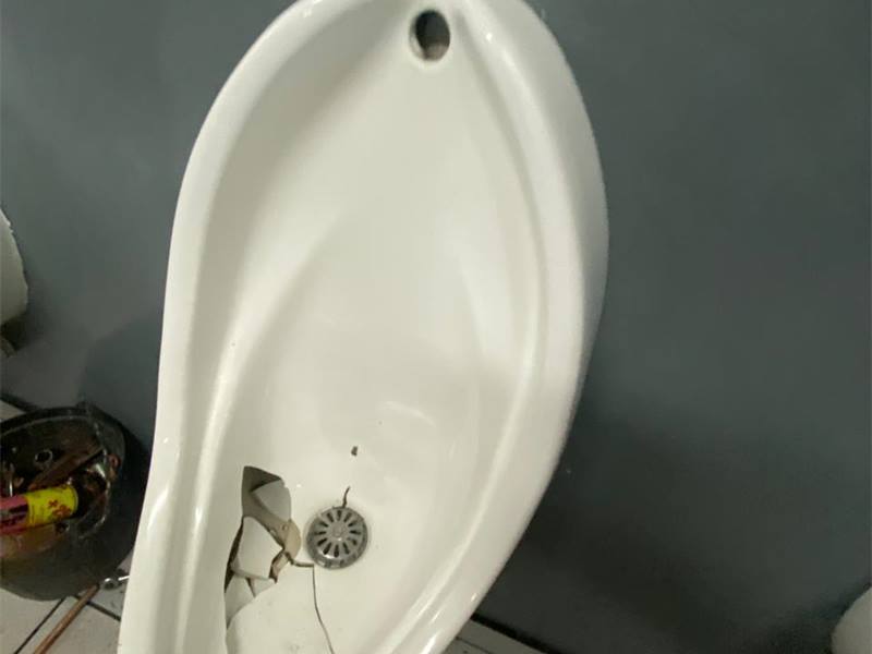 Broken urinal before repair